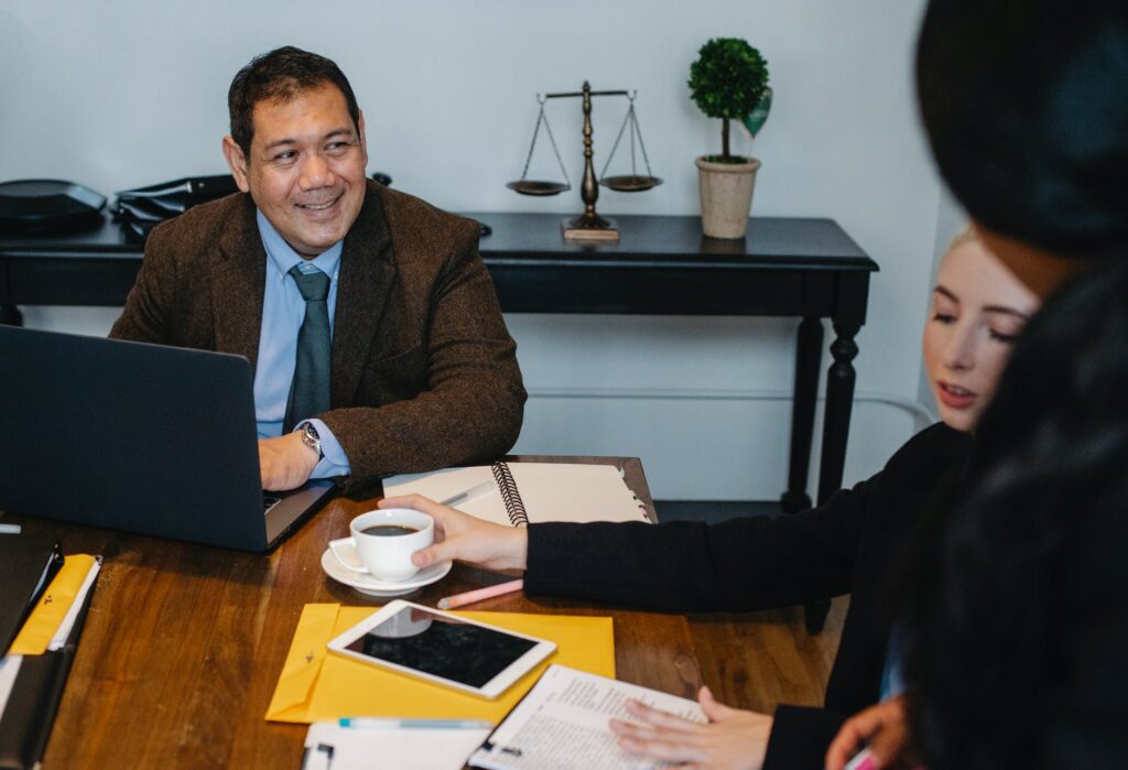 cheerful diverse colleagues discussing business project in meeting room